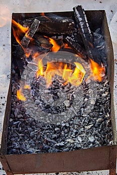 The grill is lit outside in winter. Fry kebabs