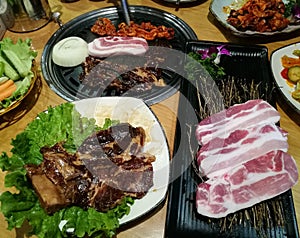 Grill pork slice on the hot BBQ pan, family dinner time, Korea food, yakiniku, Korea town