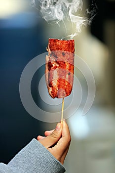 Grill pork with smoke in hand