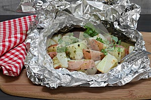 Grill roasted red potatoes in foil wrapping