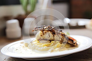 Grill sea bass fillets with crushed potatoes