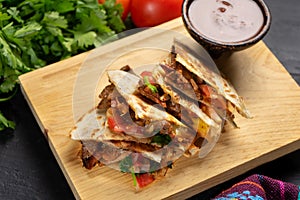 Grill steak mulitas with fresh sauce and cheese on dark background. Mexican food