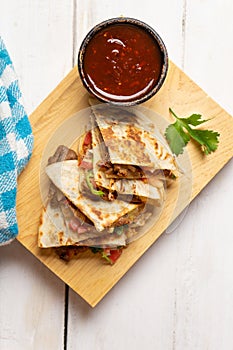 Grill steak mulitas with fresh sauce and cheese on white background. Mexican food