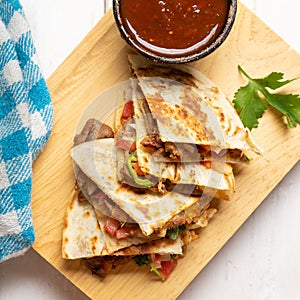 Grill steak mulitas with fresh sauce and cheese on white background. Mexican food