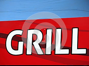 Grill writing at red table with blue background