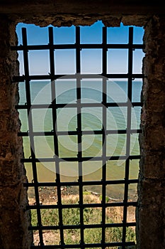 A grille in a window opening, castle in Bilhorod, Ukraine