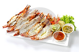Grilled 5 black tiger shrimps with boiled potatoes, slice of lime, tomato fresh vegetables and 2 chili seafood sauce on white