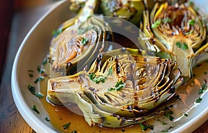 Grilled artichokes on a plate.