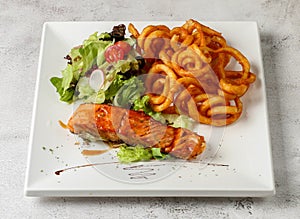 grilled atlantic salmon fish curly fries and salad served in dish isolated grey background top view singapore fast food