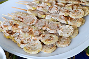 Grilled bananas on white plate