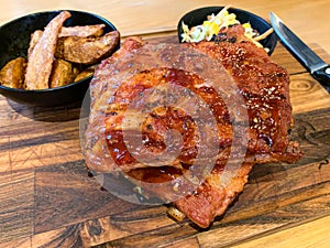 Grilled barbecue pork spare ribs rack with fried potato and coleslaw