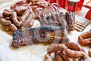 Grilled barbecue tenderloin, sausages, ribs. Roasted pork steaks, sausages, high protein unhealthy or fat food. Set of