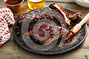 Grilled barbeque ribs with BBQ sauce and sides