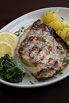 Grilled Bass with baked potatoes \