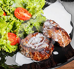 Grilled beaf steak meat with fresh vegetable salad and tomatoes