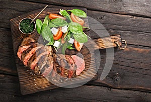 Grilled beef barbecue Striploin steak, salad and chimichurri sauce