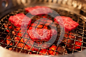 Grilled beef or pork meat grilled on charcoal grill. Cooking yakiniku Japanese style