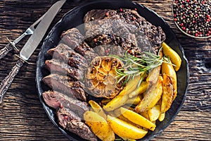 Grilled beef Rib Eye steak with garlic american potatoes rosemary salt and spices