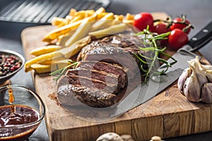 Beef Rib Eye steak with roasted potatoes bbq sauce garlic mushrooms and spices.