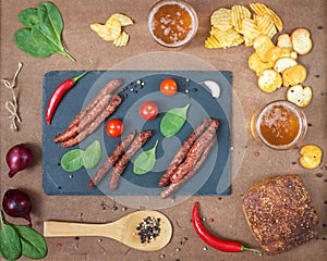 Grilled beef sausages with beer and snacks.