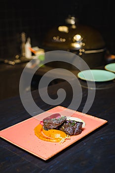 Grilled beef with sause on a pink plate