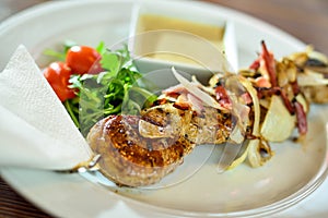 Grilled beef shishkabobs on table close up