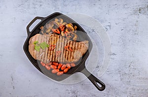 Grilled beef sirloin steaks with vegetable in grill pan