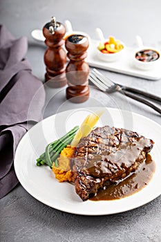 Grilled beef steak with gravy