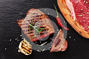 Grilled beef steak with rosemary, salt and pepper