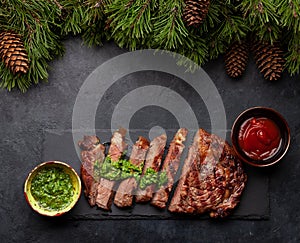 Grilled beef steak with sauces and christmas fir tree