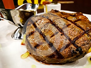 Grilled beef steak served with mashed potatoes and vegetables.