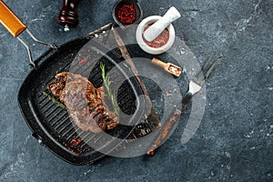 Grilled beef steak with spices in a grill pan. place for text, top view