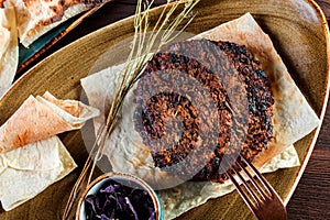 Grilled beef steak with spices served with glass of wine on a plate. Hot Meat Dishes. Top view.