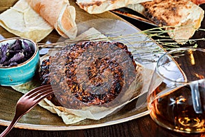 Grilled beef steak with spices served with glass of wine on a plate. Hot Meat Dishes. Top view.