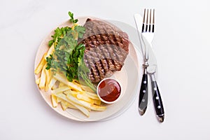 Grilled beef steak with tomatoes, french fries. Barbecue, bbq me