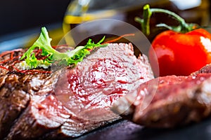 Grilled Beef steak with vegetable decoration. Grilled porterhouse steak on slate board.