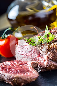 Grilled Beef steak with vegetable decoration. Grilled porterhouse steak on slate board.