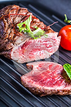 Grilled Beef steak with vegetable decoration. Grilled porterhouse steak on slate board.