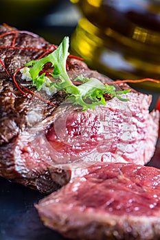 Grilled Beef steak with vegetable decoration. Grilled porterhouse steak on slate board.