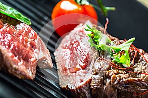 Grilled Beef steak with vegetable decoration. Grilled porterhouse steak on slate board.