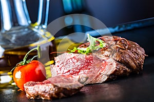 Grilled Beef steak with vegetable decoration. Grilled porterhouse steak on slate board.