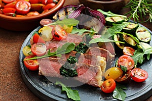 Grilled beef steak with vegetables and salad