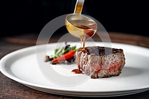 Grilled beef tenderloin steak on a white plate