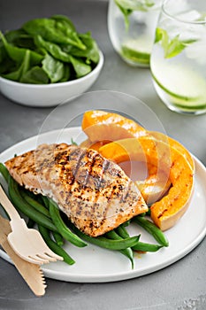 Grilled blackened salmon fillet with grilled squash