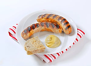 Grilled bratwursts with mustard