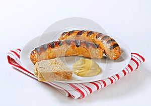 Grilled bratwursts with mustard