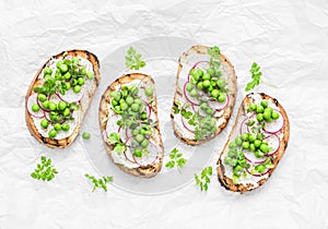 Grilled bread, soft cheese, green peas, radishes and micro greens spring sandwiches. Healthy eating, slimming, diet lifestyle conc