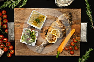 Grilled Bream fish on wooden board. Healthy food