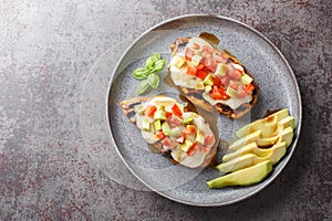 Grilled California Avocado Chicken marinates in balsamic vinaigrette topped with fresh mozzarella, avocado, and tomato closeup on