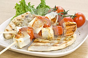 Grilled cheese(haloumi) and tomato souvlaki photo